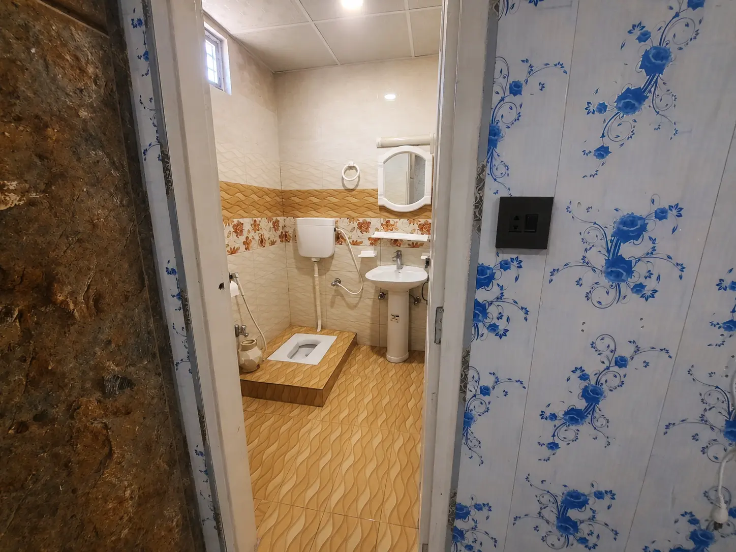 MH Apartment attached bathroom with sink and mirror